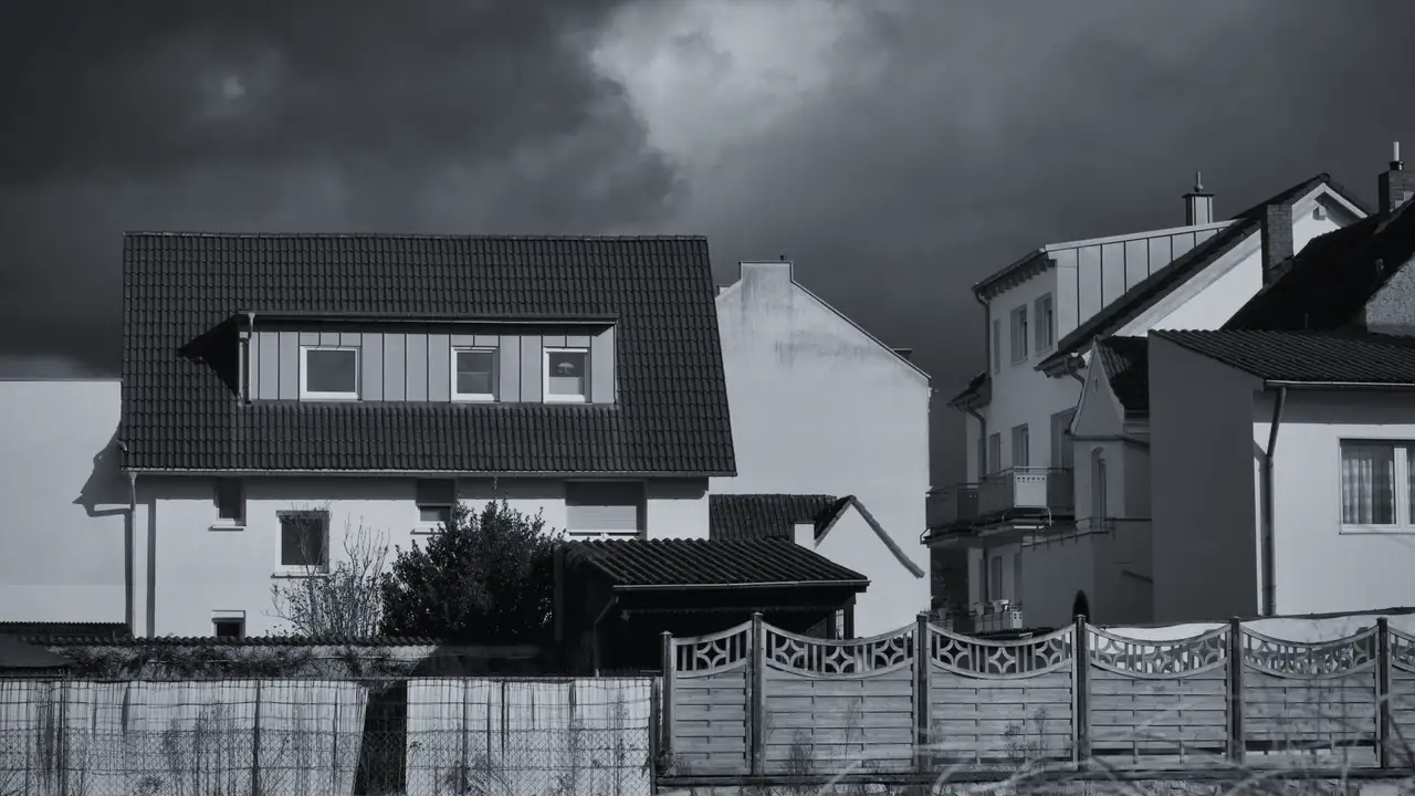 Dark storm clouds over a row of houses