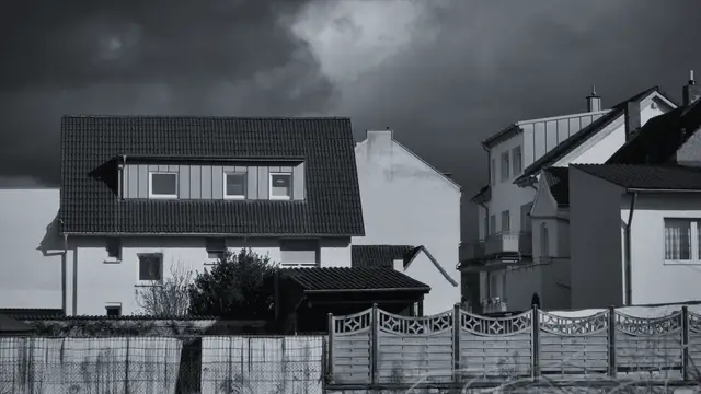 Dark storm clouds over a row of houses